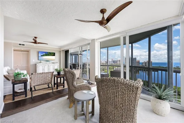 a living room with furniture and a floor to ceiling window