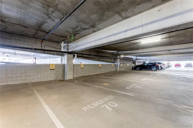 a view of parking garage with cars