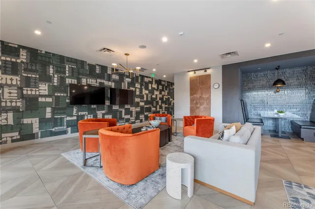 a living room with patio furniture and a potted plant