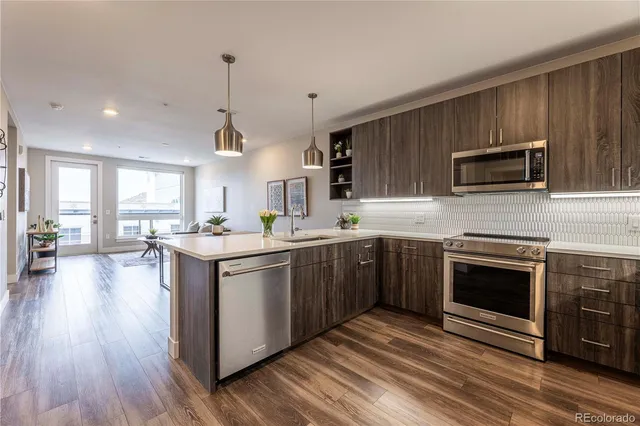 a kitchen with a sink stove and microwave