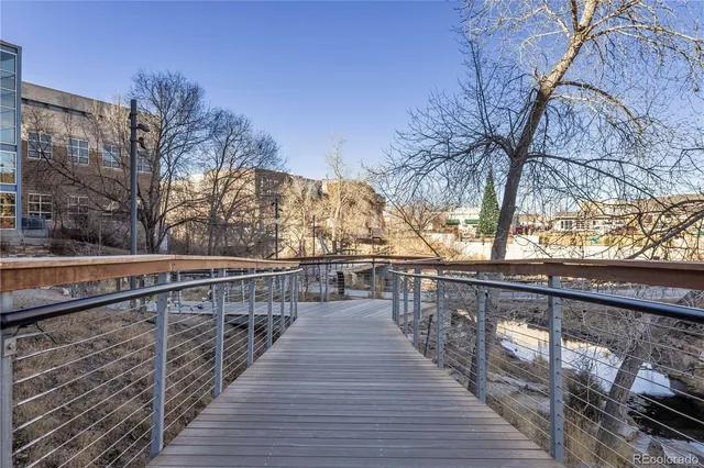 a view of balcony with wooden floor and trees