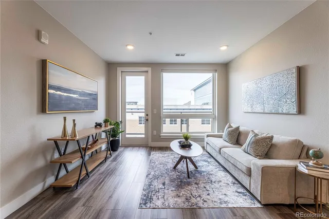 a living room with furniture and a wooden floor