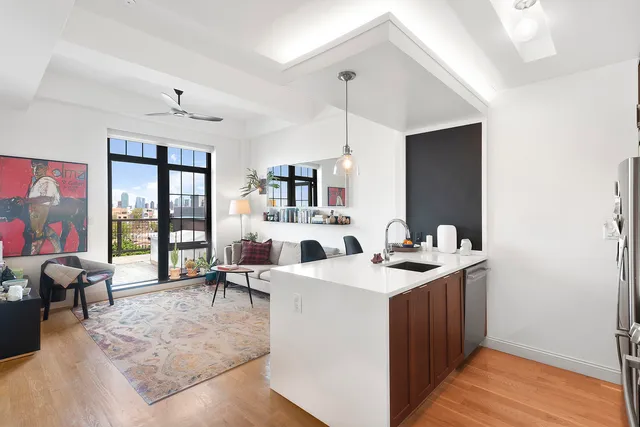 a view of living room with granite countertop furniture and a flat screen tv