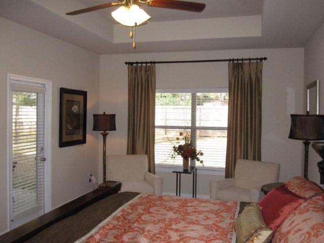 135 Maddox Street Santa Rosa Beach, FL 32459 - Photo 3 of 19 a bedroom with a bed and a chandelier
