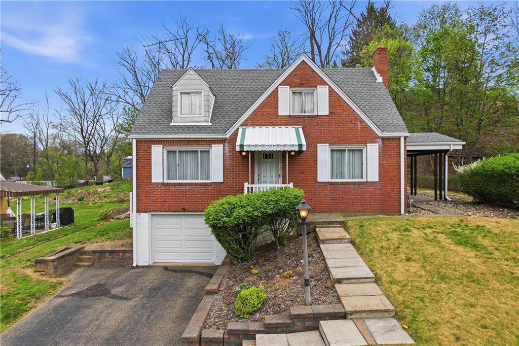 a front view of a house with garden