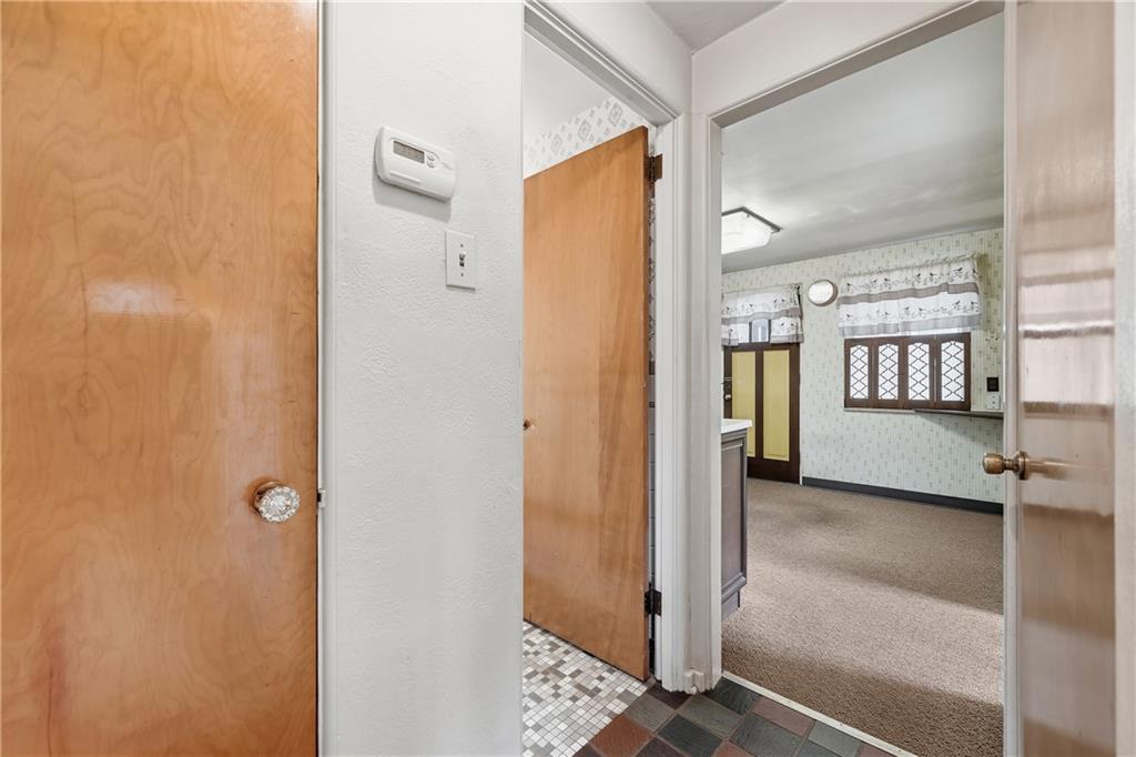 824 Vilsack Road Glenshaw, PA 15116 - Photo 11 of 44 a view of a hallway with wooden floor and windows