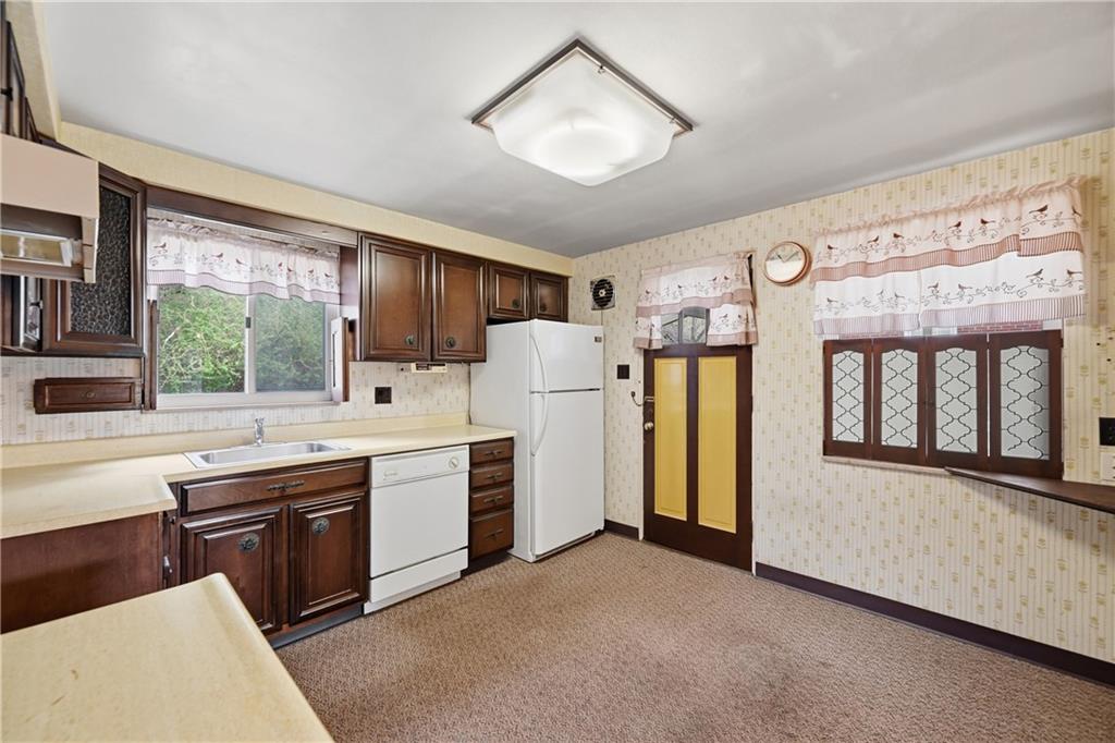824 Vilsack Road Glenshaw, PA 15116 - Photo 12 of 44 a kitchen with stainless steel appliances granite countertop a refrigerator a sink dishwasher a stove and white countertops with wooden floor