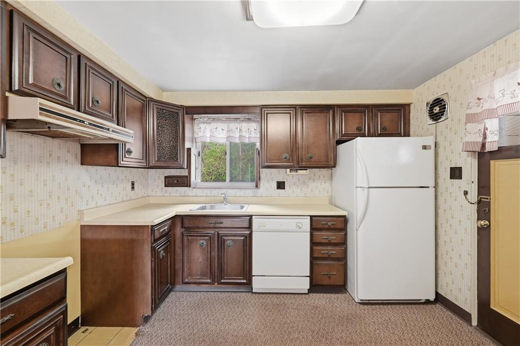 824 Vilsack Road Glenshaw, PA 15116 - Photo 13 of 44 a kitchen with a sink a refrigerator and cabinets
