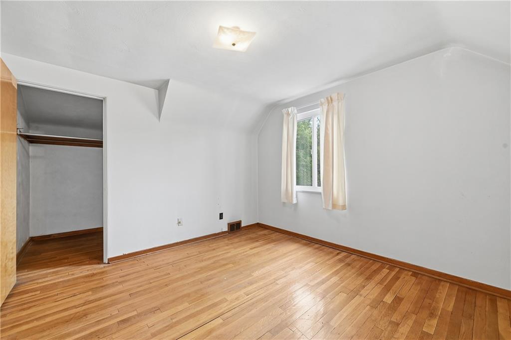 824 Vilsack Road Glenshaw, PA 15116 - Photo 29 of 44 an empty room with wooden floor and windows