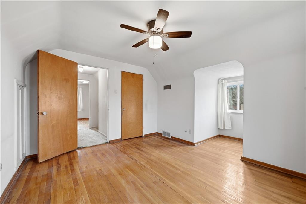 824 Vilsack Road Glenshaw, PA 15116 - Photo 34 of 44 a view of an empty room with wooden floor and a ceiling fan