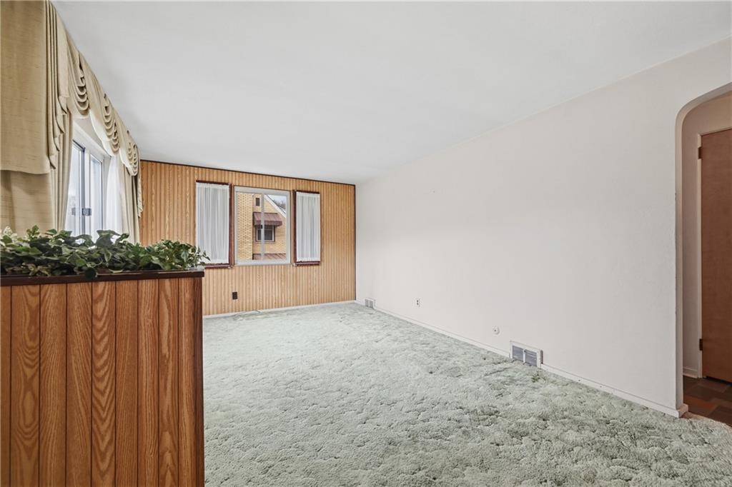 824 Vilsack Road Glenshaw, PA 15116 - Photo 6 of 44 a view of a big room with wooden floor and windows