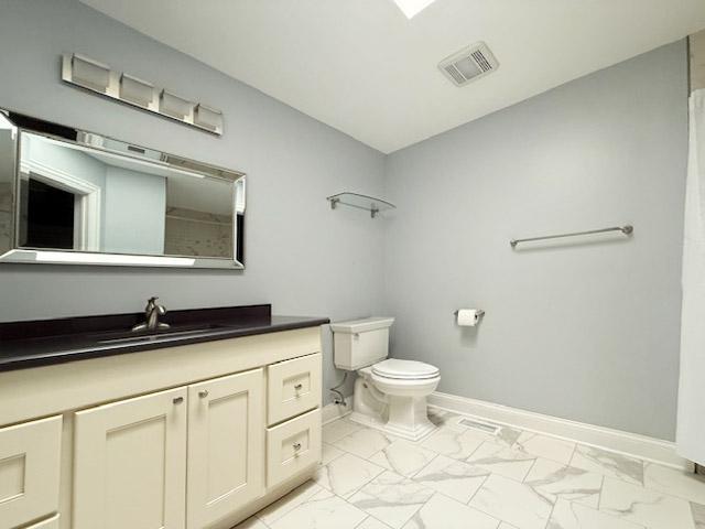 1341 Rose Boulevard Buffalo Grove, IL 60089 - Photo 8 of 17 a bathroom with a granite countertop sink a toilet and a mirror