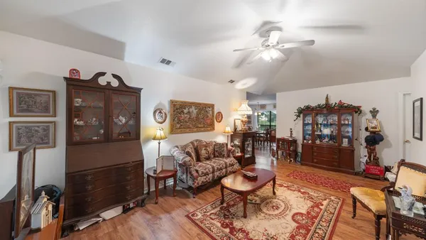 a living room with furniture a rug and a chandelier