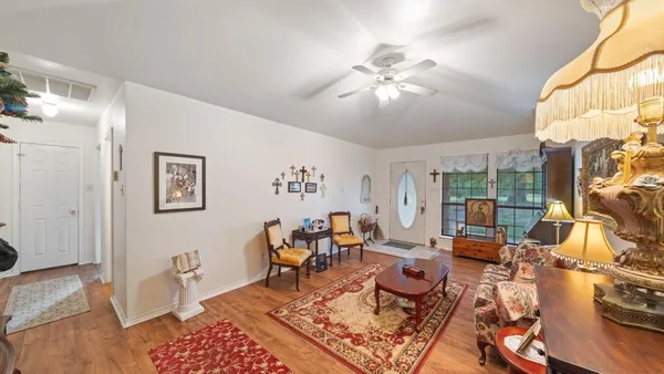 a living room with furniture and a chandelier
