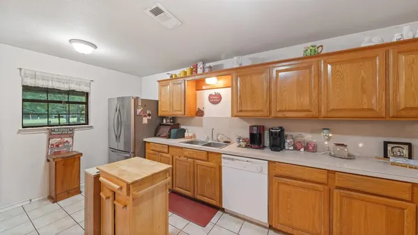 a kitchen with stainless steel appliances granite countertop a refrigerator sink and cabinets