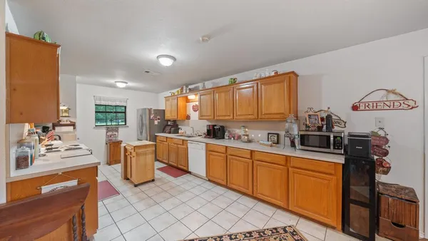 a kitchen with granite countertop appliances cabinets and furniture