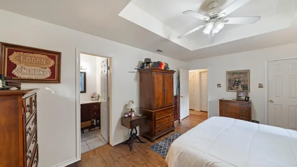 a bedroom with furniture and a flat screen tv