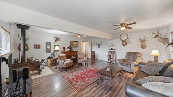 a living room with furniture and wooden floor