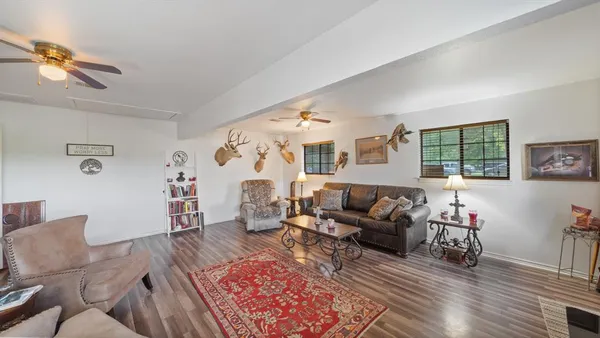 a living room with furniture and wooden floor