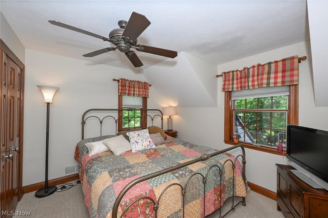 3530 Brush Road Richfield, OH 44286 - Photo 22 of 35 Bedroom with light colored carpet, a closet, ceiling fan, and multiple windows