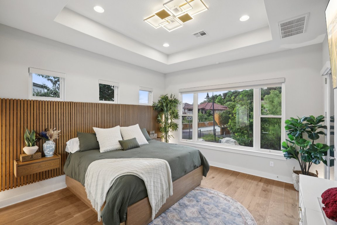 101 Cascading Water Place Austin, TX 78734 - Photo 15 of 36 a bedroom with a large bed and a large window