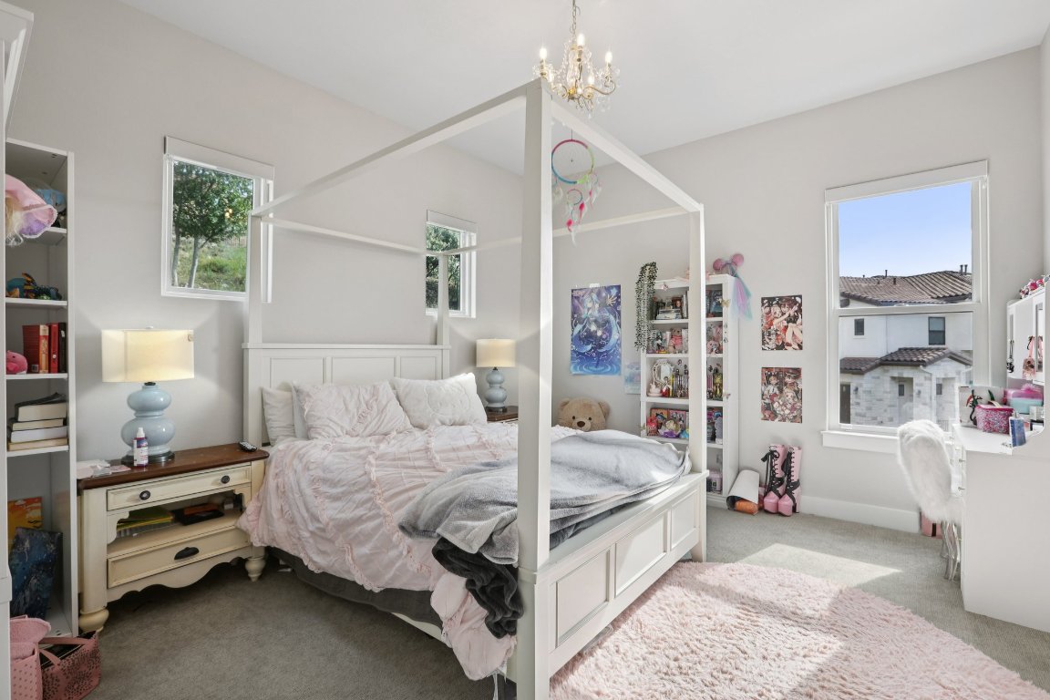 101 Cascading Water Place Austin, TX 78734 - Photo 27 of 36 a bedroom with a bed and large window