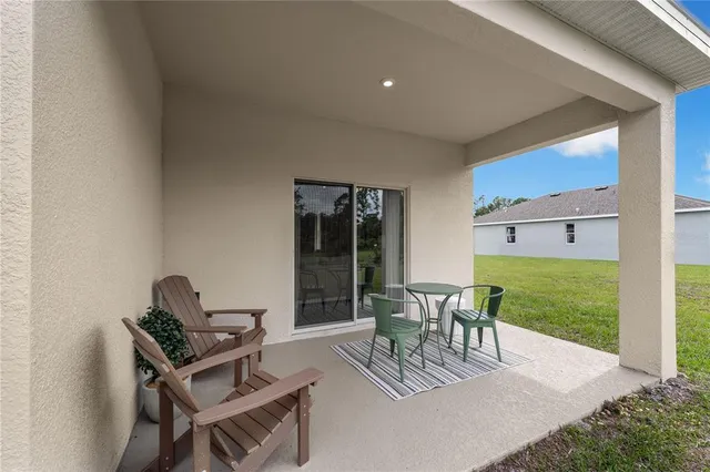 a view of a patio with a dining table and chairs