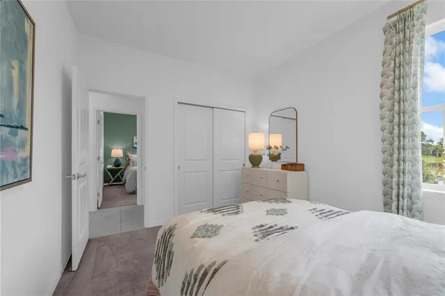 a bedroom with a bed and a mirror