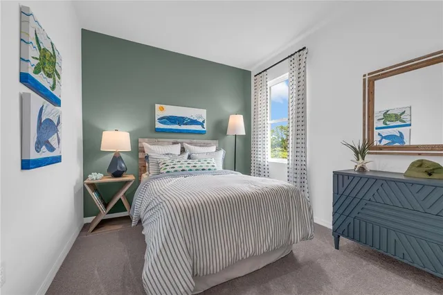 a bedroom with a bed and a painting on the wall