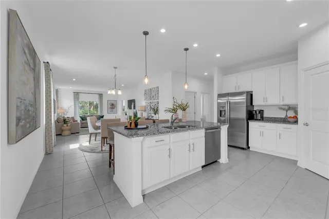 a kitchen with stainless steel appliances kitchen island granite countertop a sink and cabinets