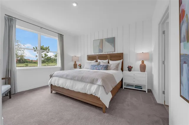 a bed sitting in a bedroom next to a window