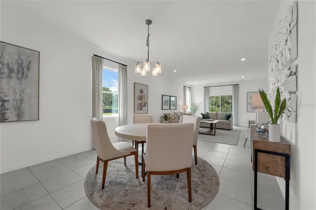 a dining room with furniture potted plants and wooden floor