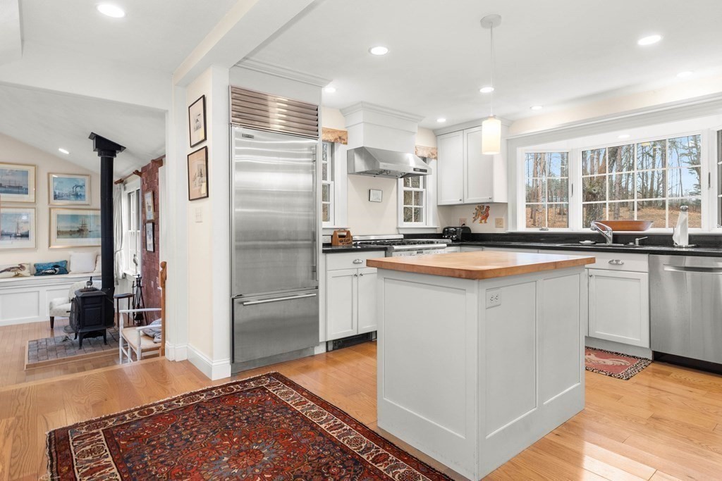 5 Northedge Road Hamilton, MA 01982 - Photo 3 of 42 a kitchen with stainless steel appliances granite countertop a refrigerator a sink and white cabinets