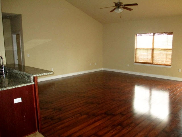511 Pheasant Trail Crestview, FL 32536 - Photo 34 of 50 a view of a livingroom with wooden floor and a ceiling fan