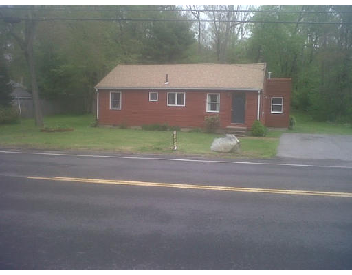 a view of a brick house with a yard