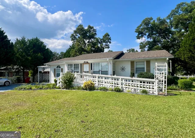 a front view of house with yard and green space