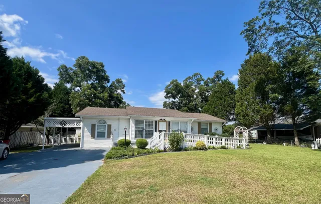 a front view of a house with a garden