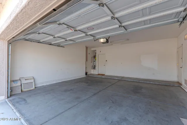 an empty room with closet and a ceiling fan