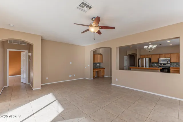 a kitchen with stainless steel appliances granite countertop a refrigerator and a stove top oven