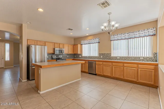 a kitchen with granite countertop a refrigerator and a sink
