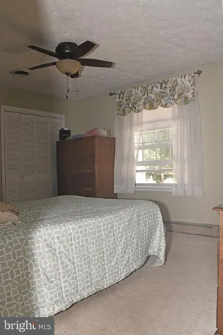 a bed sitting in a room next to a window