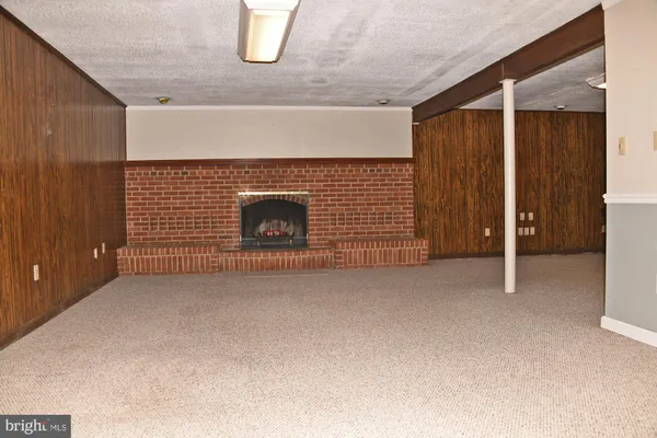 a view of empty room with fireplace