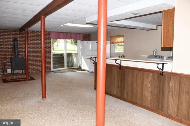 a view of a hallway with furniture and window