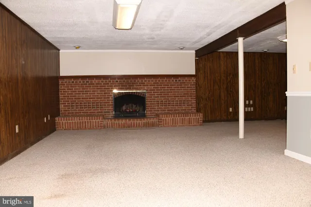 a view of an empty room with a fireplace