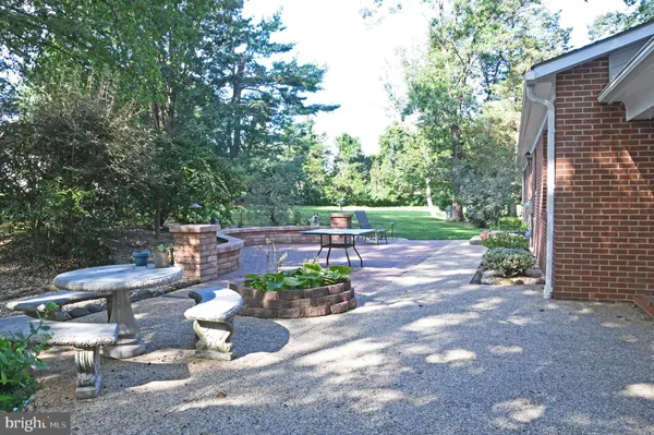 a view of a porch with furniture and a yard