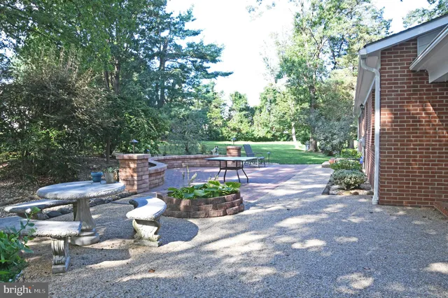 a view of a porch with furniture and a yard