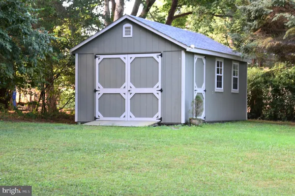 a house that has a big yard with wooden fence