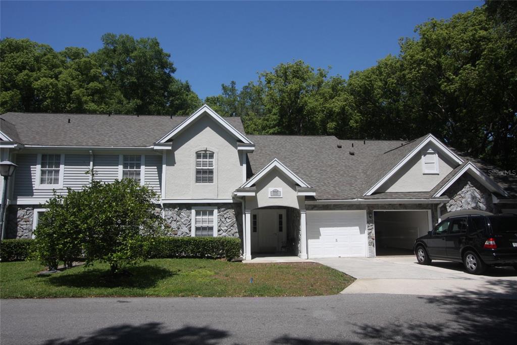 810 Loch Calder, Unit 25 Apopka, FL 32712 - Photo 1 of 24 a front view of a house with a yard and garage