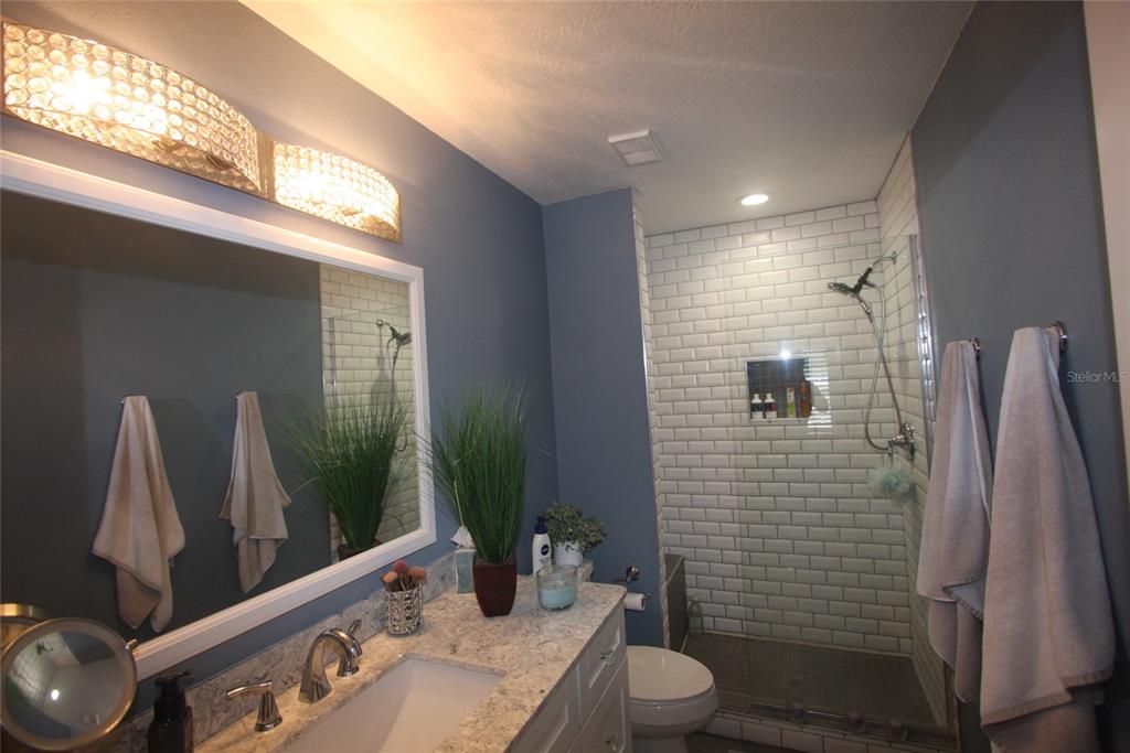 810 Loch Calder, Unit 25 Apopka, FL 32712 - Photo 13 of 24 a bathroom with a sink toilet and shower