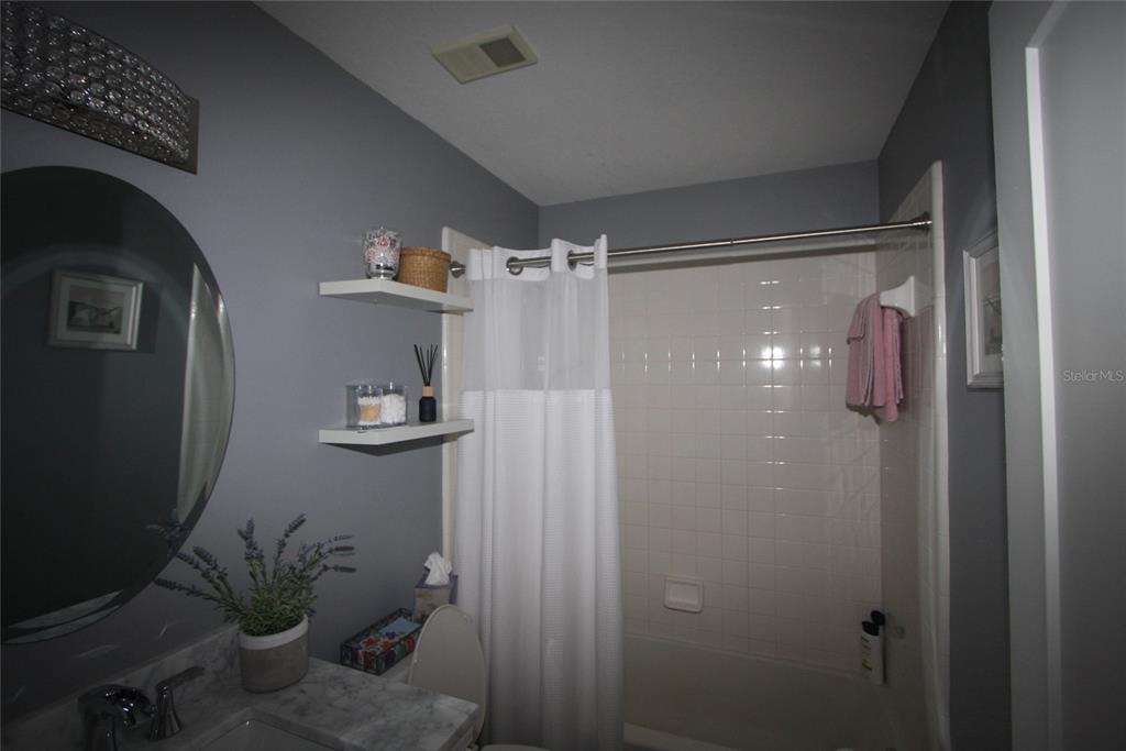 810 Loch Calder, Unit 25 Apopka, FL 32712 - Photo 15 of 24 a bathroom with a shower and a mirror